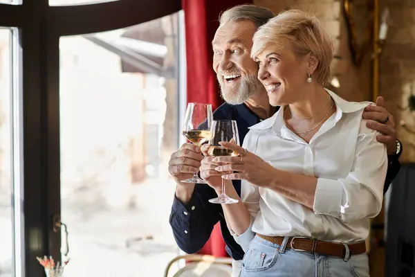 A happy couple toasts with wine at a nostalgic cafe, enjoying each others company. — Stock Photo