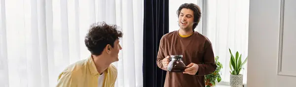Gay couple share a tender moment in a stylish apartment while enjoying a morning ritual, banner — Stock Photo