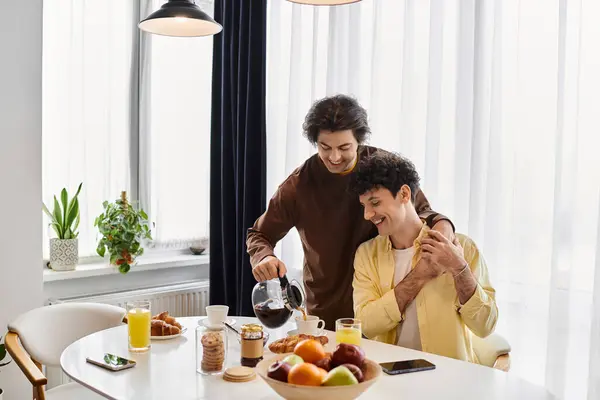 In a stylish apartment, a gay couple enjoys breakfast, sharing love and laughter over coffee. — Stock Photo