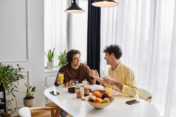 Gay couple enjoys a joyful breakfast together in a bright, contemporary living space. — Stock Photo