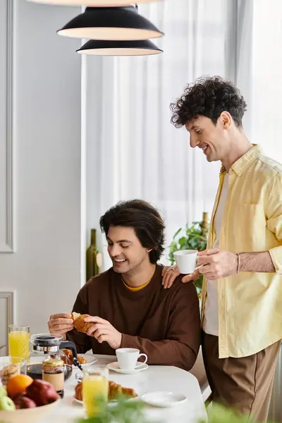 Gay couple enjoys a cozy morning in their stylish apartment, embracing love and happiness. — Stock Photo