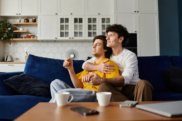 Gay couple relax together in a stylish apartment, enjoying each others company and laughter. — Stock Photo