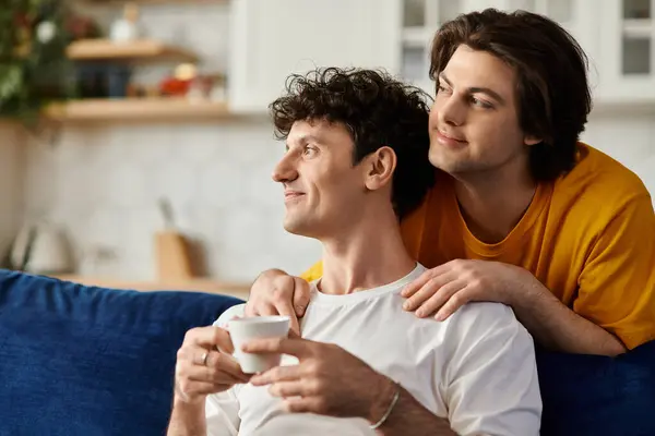 Two men share a loving moment in their stylish apartment, enjoying each others company. — Stock Photo