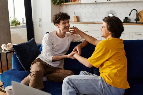 Two gay men share a tender moment in their stylish apartment, enjoying each other's company. — Stock Photo