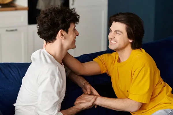 Two lgbt men share a tender moment in their stylish apartment, showcasing their love and connection. — Stock Photo