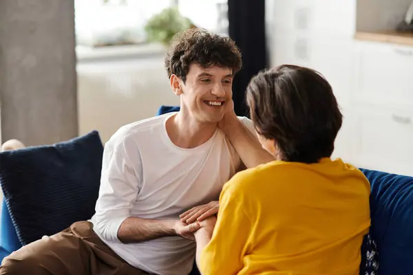 Two good-looking gay men share a tender moment in their stylish apartment, celebrating love. — Stock Photo