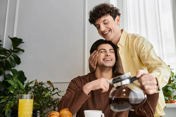 Gay couple enjoy a cozy morning together in their stylish apartment with coffee and pastries. — Stock Photo