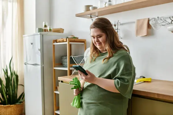 In a cozy home, a young woman with Down syndrome smiles confidently while using her phone. — Stock Photo
