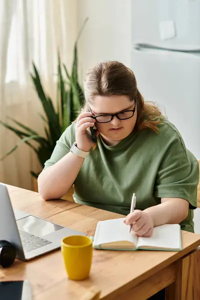 Confident young woman with Down syndrome studies on the phone in a cozy home. — Stock Photo