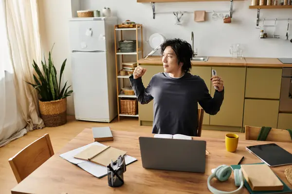Handsome young man engages in online studies at home, embracing comfort and focus in kitchen. — Stock Photo