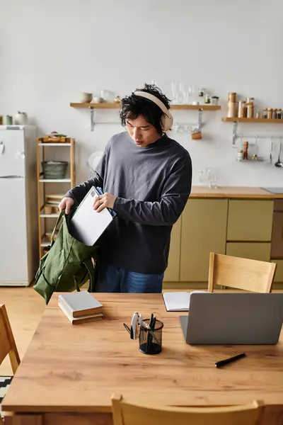 A young Asian student focuses on online learning with his laptop at home. — Stock Photo