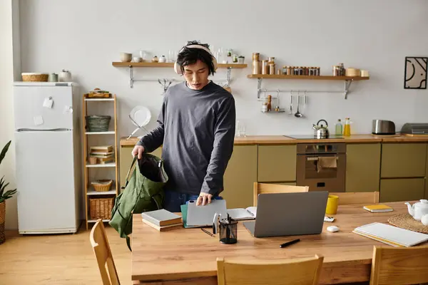 Handsome young man engaged in online learning from his cozy home study area at midday. — Stock Photo
