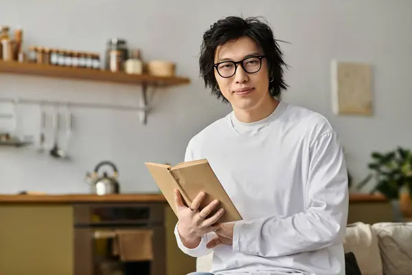 Schöner junger asiatischer Mann genießt Online-Studium von zu Hause aus in einer komfortablen Umgebung. — Stockfoto
