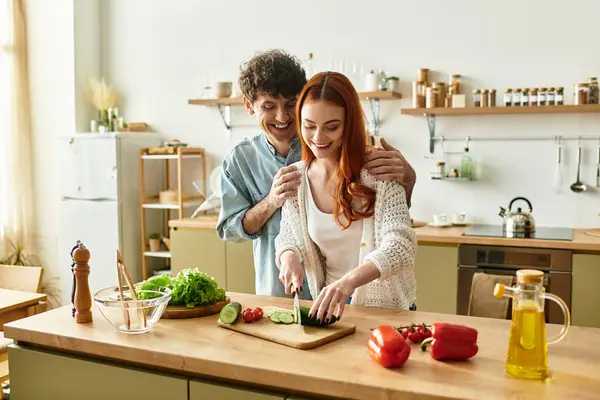 A couple shares laughs and quality time while cooking healthy meals in their cozy kitchen. — Stock Photo