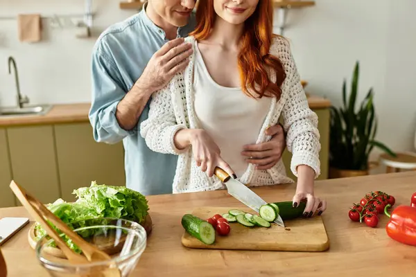 Joyful couple enjoys cooking together, creating a loving atmosphere in their kitchen at home. — Stock Photo