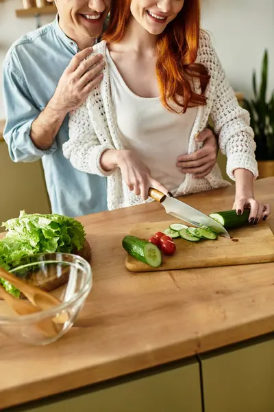 Young couple enjoys quality time cooking together, surrounded by warmth and affection at home. — Stock Photo