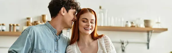 Loving couple shares joyful laughter while cooking in their warm and inviting kitchen space — Stock Photo