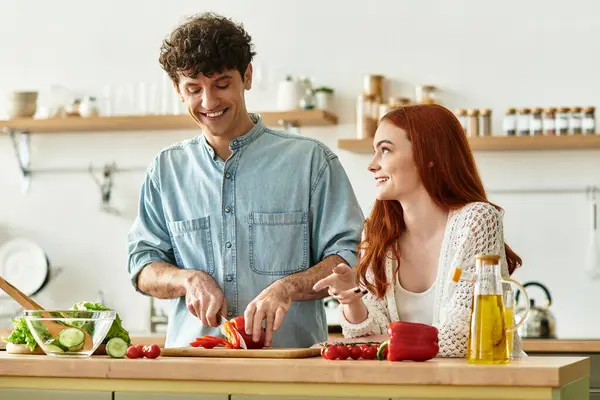 A young couple shares laughter and love while preparing a meal together in their kitchen — Stock Photo