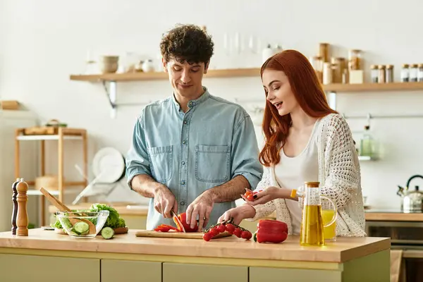 A young couple shares laughter and love as they prepare a meal together in their warm home kitchen. — Stock Photo
