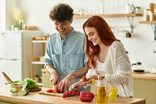 A loving couple shares joyful moments and laughter while cooking together at home. — Stock Photo