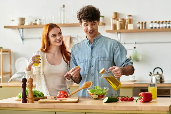 Young couple bonds over cooking in their cozy kitchen, sharing smiles and laughter. — Stock Photo