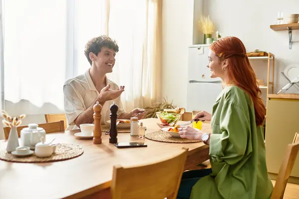 Young couple bonds over a lovingly prepared meal at home while sharing moments of joy. — Stock Photo