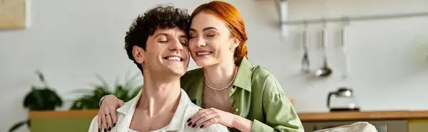 A couple smiles at each other, savoring the warmth of love during a cozy day at home. — Stock Photo