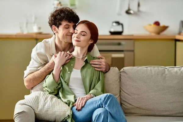 Joyful couple relaxes together at home, embracing love and connection in a cozy environment. — Stock Photo