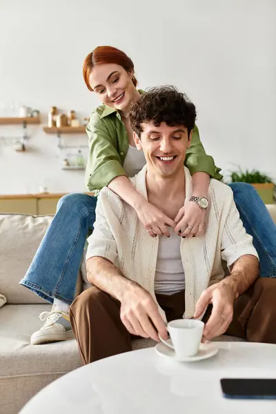 A lovely couple enjoys quality time at home while sharing smiles and coffee in a cozy atmosphere. — Stock Photo