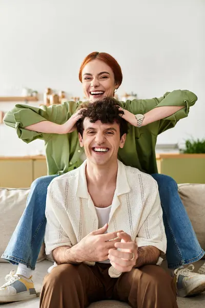A couple laughs joyfully while bonding at home, embracing each others company in love. — Stock Photo