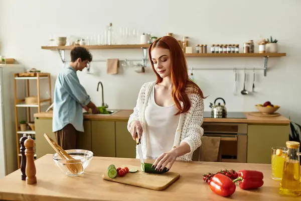 In a warm kitchen, a young couple shares a joyful cooking experience, bonding over meal prep. — Stock Photo