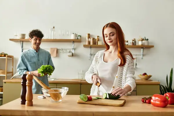 Loving couple shares a joyful moment preparing a meal, surrounded by fresh ingredients and warmth. — Stock Photo