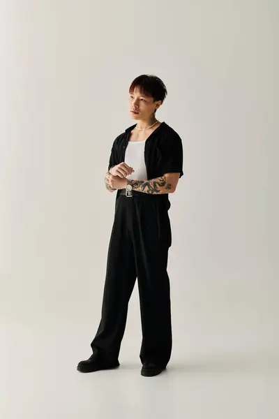 Young and fashionable Asian man stands poised, showcasing modern style and self assurance. — Stock Photo