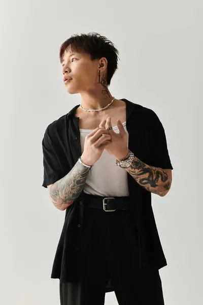 Fashionable young man showcases a unique style in a minimalist studio with creative lighting. — Stock Photo