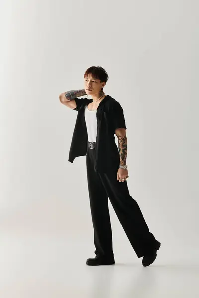 A young handsome Asian man showcases his unique style while striking an elegant pose indoors. — Stock Photo