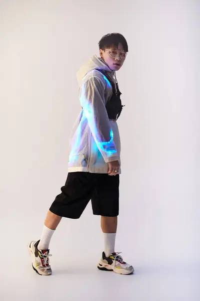 A fashionable young Asian man poses confidently in contemporary attire, exuding style and charm. — Stock Photo