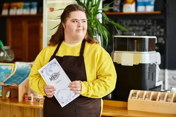 In a vibrant cafe, a strong young woman with Down syndrome confidently holds a menu. — Stock Photo