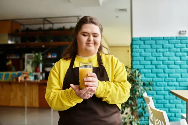 A young woman with Down syndrome radiates confidence while savoring a drink in a colorful cafe. — Stock Photo