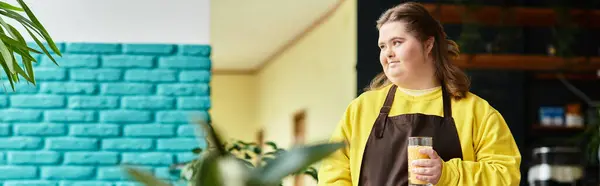 Confident young woman with Down syndrome in a colorful cafe, radiating warmth with her drink. — Stock Photo