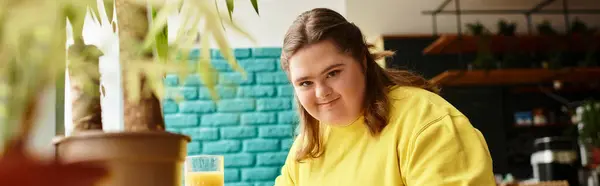 In a lively cafe, a confident young woman with Down syndrome savors a bright moment. — Stock Photo