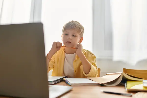 A young boy engages with his laptop, exploring knowledge and creativity while at home. — Stock Photo
