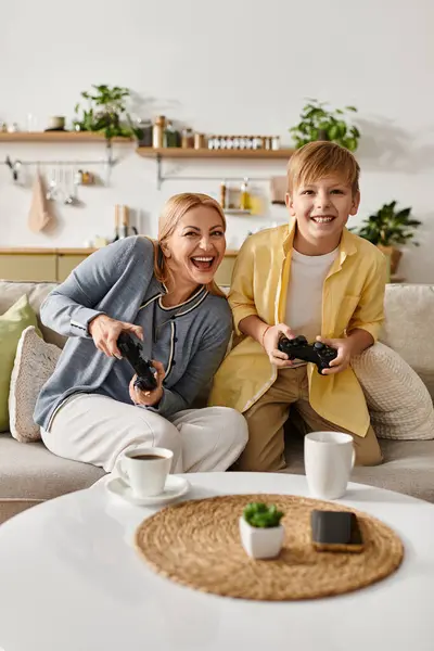 Mother and son share laughter as they enjoy gaming together in their inviting living room space. — Stock Photo