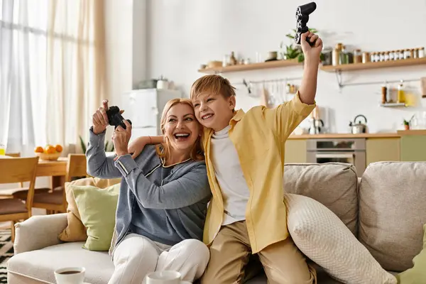 Engaging in a vibrant gaming session, a mother and her son share laughter and excitement together — Stock Photo