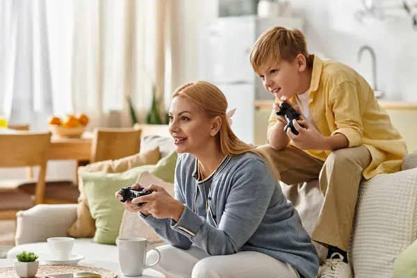 Mother and son engage in fun gaming together at home, sharing laughter and connection in leisure. — Stock Photo