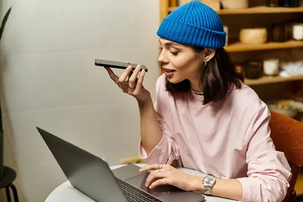 Young woman enjoying her remote work in a stylish cafe, engaged in a voice call. — Stock Photo