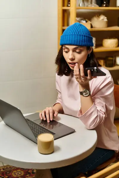 Schöne junge Frau verrichtet Fernarbeit in einem gemütlichen Café, konzentriert auf ihre Aufgaben mit Kaffee. — Stockfoto
