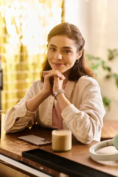 Bright and inviting cafe atmosphere with a stylish young woman savoring her beverage — Stock Photo