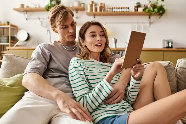 A happy couple enjoys laughter and love while relaxing at home with a fun activity. — Stock Photo