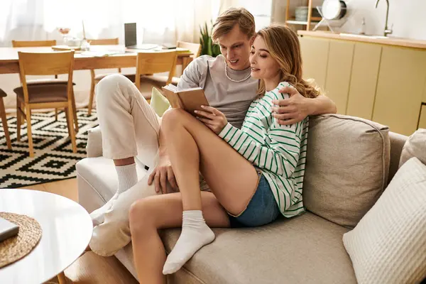 Loving couple enjoys a quiet afternoon at home, immersed in a story on a sunny day. — Stock Photo