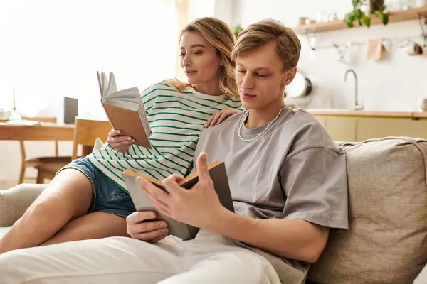 A young couple relaxes at home, enjoying special moments while reading their favorite books. — Stock Photo